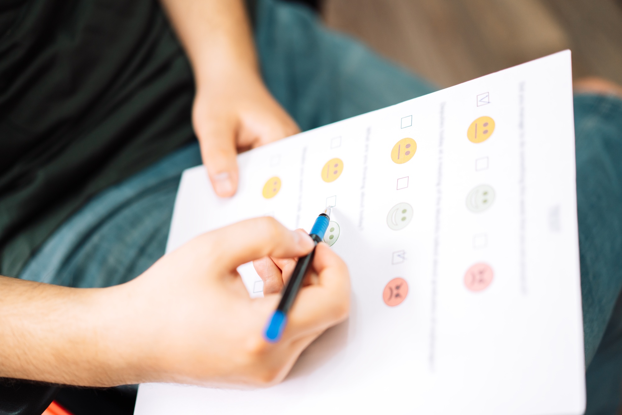man taking a psychological test with emoticons